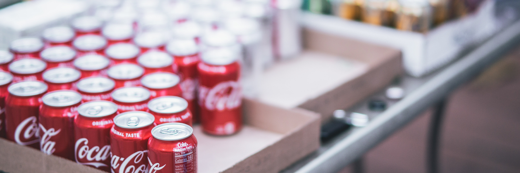 A box with aluminum cans of Coca-Cola